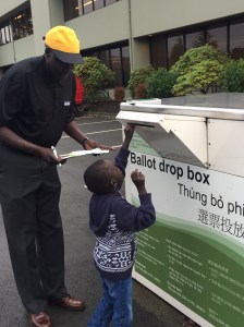 Voter returning ballot at drop box